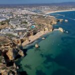 War Turns Russia’s Beach Season Into A Security Test Coastal city with cliffs, beaches, and boats on turquoise water