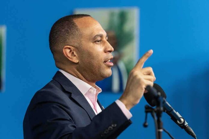 shutterstock_2236452443 Man speaking at a microphone with raised finger