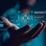 ChatGPT’s Teen Overhaul Comes at a Crucial Time Hand holding a glowing AI interface with chat and code elements