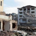 Collapsed apartment buildings amid heavy rubble