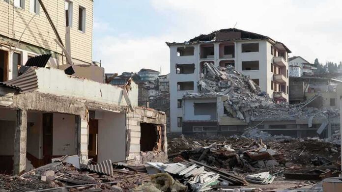 Collapsed apartment buildings amid heavy rubble