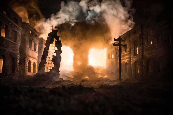 Street with burning buildings and heavy smoke at night