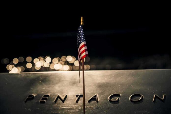 Small American flag on a memorial with bokeh lights at night