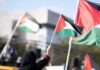Concert Speech Sparks Free-Speech Brawl Person waving a Palestinian flag at a rally