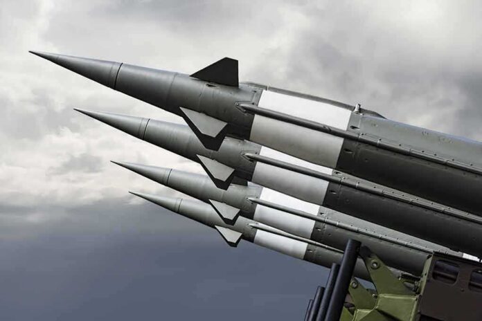shutterstock_505313755 Missiles mounted on a launcher against a cloudy sky