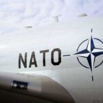 Europe’s American Security Blanket Just Got Smaller Aircraft fuselage with NATO emblem and lettering