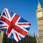 Settlement Crackdown Sparks Alliance Rift Union Jack flag with Elizabeth Tower in the background