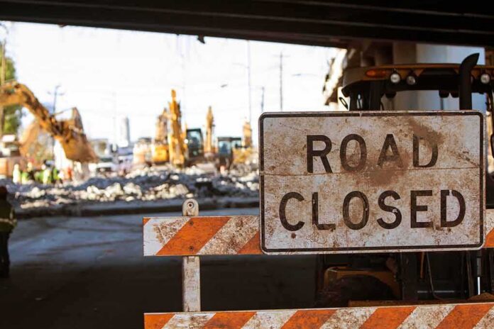 shutterstock_671383471 Road closed sign at construction site under overpass