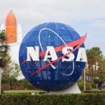 The Next 5G Coverage Zone Isn’t on Earth NASA globe sign at visitor center with space shuttle booster in background