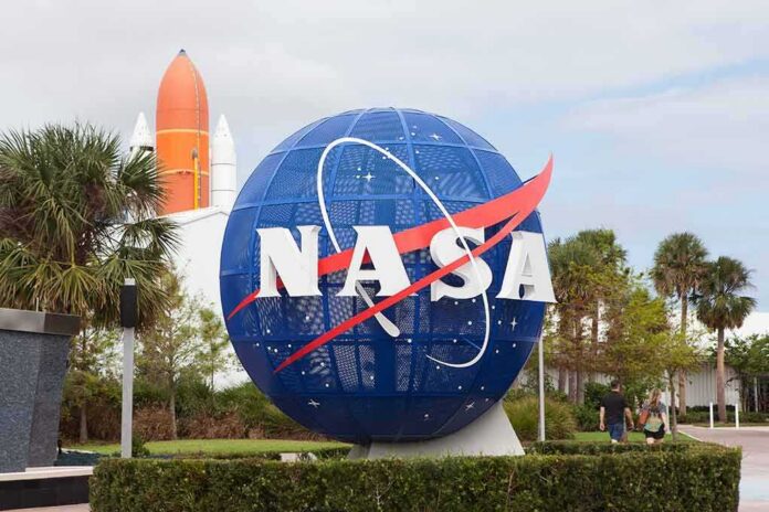 shutterstock_742595803 NASA globe sign at visitor center with space shuttle booster in background