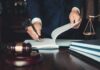 Ex-Fiancé Named – Case Explodes Lawyer signing documents at a desk with gavel and scales