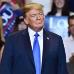 Deterrence Gambit: Trump Dares Moscow, Beijing Donald Trump at a rally wearing a dark suit and blue tie