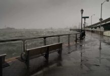 stormy waterfront promenade with benches and choppy water