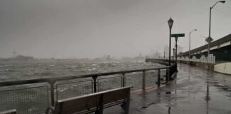 stormy waterfront promenade with benches and choppy water