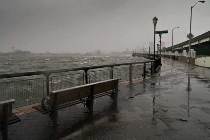 shutterstock_117079918 stormy waterfront promenade with benches and choppy water