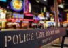 Police barrier with city nightlife in the background