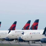 Row of commercial airplanes parked on the tarmac