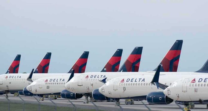 Row of commercial airplanes parked on the tarmac