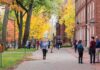Campus-Wide Ban Sparks Cornell Uproar Walter Jones and students walking on a leafy campus path in autumn