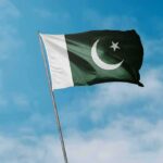 An Unexpected Player Is Bridging Two Bitter Rivals Pakistan flag waving against a blue sky