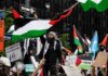 Antisemitism Label Weaponized on Campus? Protesters wave Palestinian flags at a city street demonstration