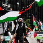 Antisemitism Label Weaponized on Campus? Protesters wave Palestinian flags at a city street demonstration