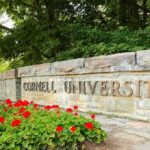 Campus Timeline Vanishes After Frat Drug Bust Cornell University stone entrance sign with red flowers