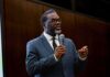 Crime First, Not Cash: D.C. Warns Chicago Man in a suit speaking into a microphone