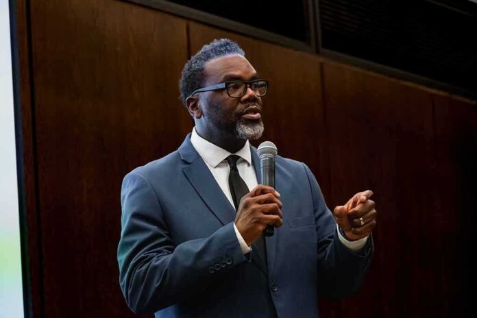 Man in a suit speaking into a microphone