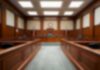 Empty courtroom with wooden benches and judge's bench