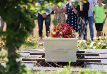 Dad Almost Buried His Teen Daughter Alive White coffin with red flowers at outdoor burial