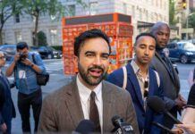Warrant-Or-Leave: NYC’s Wild Play Zohran Mamdani speaking to reporters on a city sidewalk