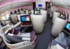Business class cabin with lie-flat seats and personal screens