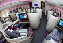 Business class cabin with lie-flat seats and personal screens