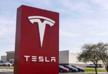 Tesla dealership sign in front of parking lot