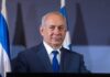 Israel’s Election Math Reveals A Major Political Puzzle man in suit at podium with microphones