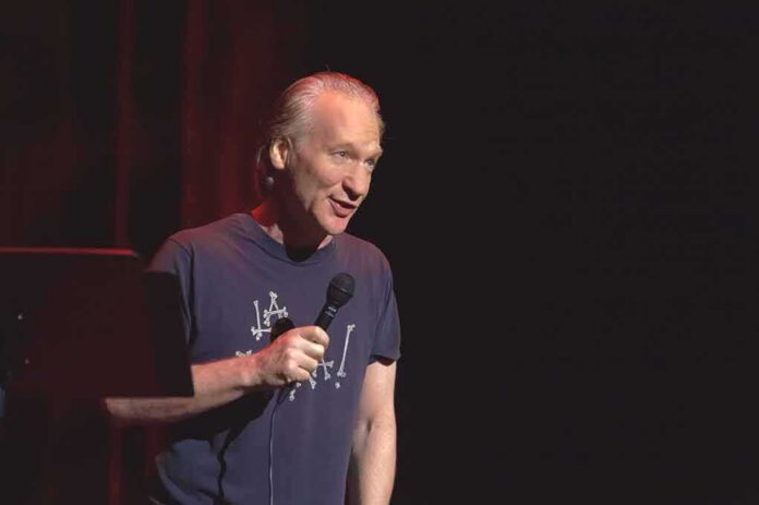 shutterstock_83139061 Bill Maher performing stand-up with a microphone on stage