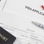 Visa application form with passport and pen