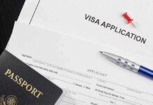 Visa application form with passport and pen