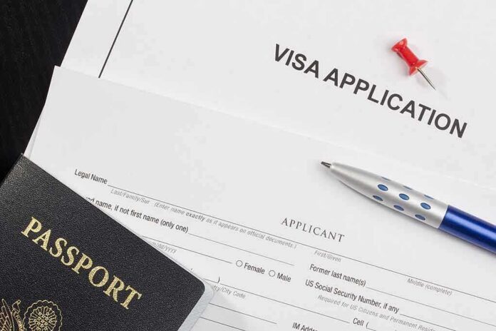 shutterstock_98569004 Visa application form with passport and pen